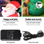 Inflatable Santa with pegs, ropes, and power adapter.