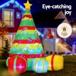 Inflatable Christmas tree with colourful lights outdoors.