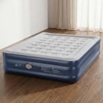 Inflatable mattress in a room with wooden floor.