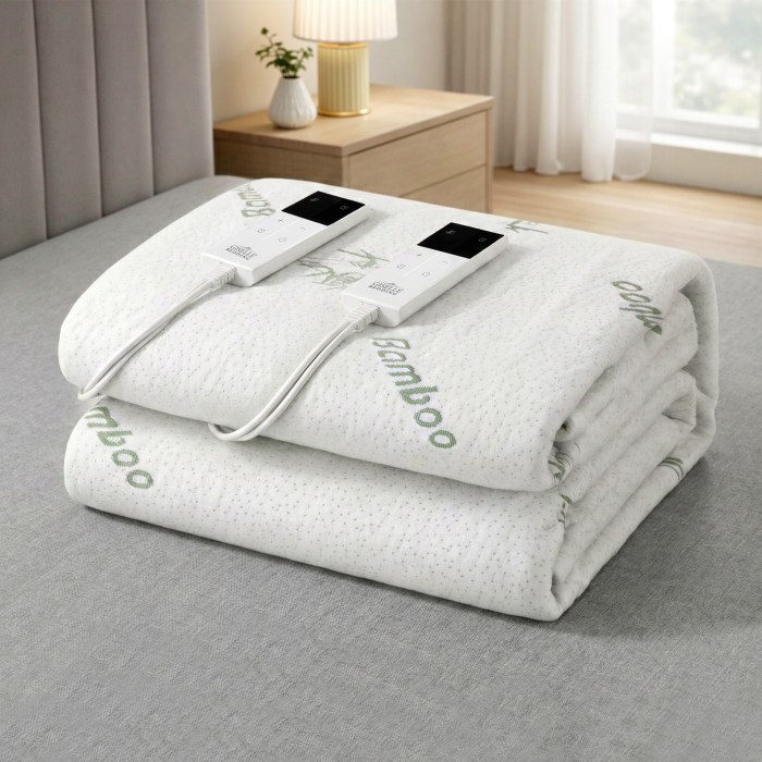 Folded bamboo electric blanket with controls on bed.