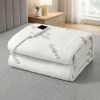 Folded bamboo electric blanket on bed.