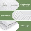 Bamboo mattress protector with fitted skirt and delicate edges.