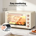 devanti 60l convection oven electric fryer ovens 2000w cream Beige electric oven with food inside on counter.