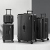 Four sleek black suitcases on display.