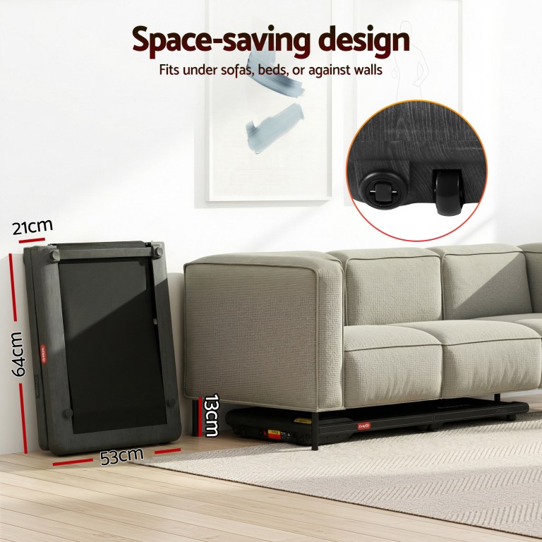 Treadmill stored under couch for space-saving.