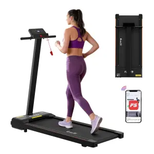 Woman jogging on foldable treadmill with app connectivity.