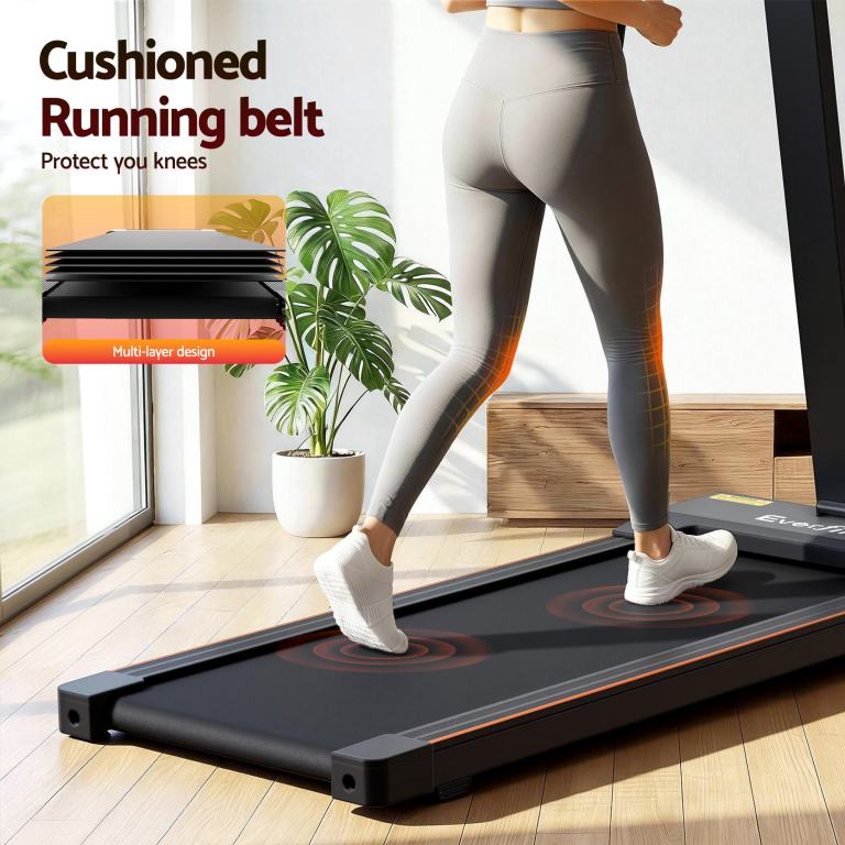 everfit walking pad treadmill 2 in 1 foldable for home gym 40cm wide belt 12 programs with app Woman using treadmill with cushioned running belt.