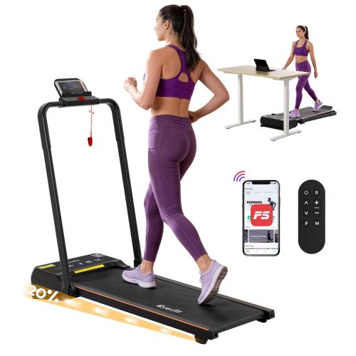 Woman using foldable treadmill with remote and app control.