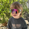 Child wearing sunglasses outside, shirt says Fun Vibes.
