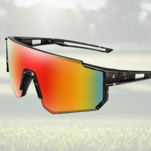 Stylish rainbow sunglasses on grassy field background.