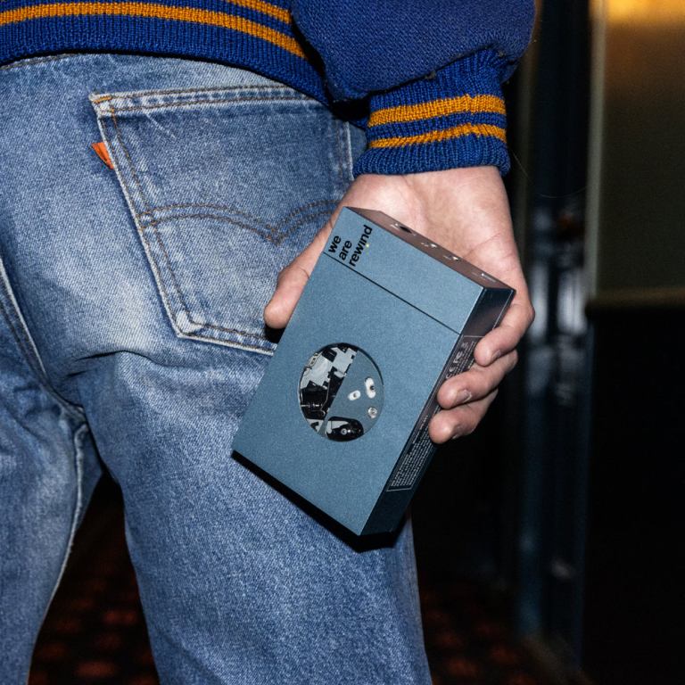 we are rewind portable cassette player & recorder kurt, blue Person holding retro cassette player, wearing denim jeans.