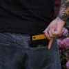 Pocketing a black and yellow cassette tape