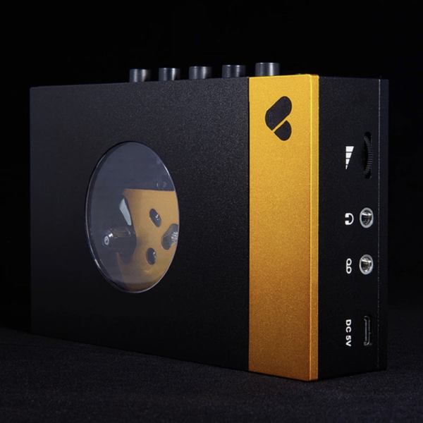 Compact audio device with gold accents and ports.