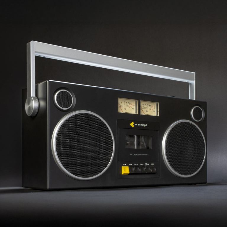 Retro boombox with dual speakers and cassette player.