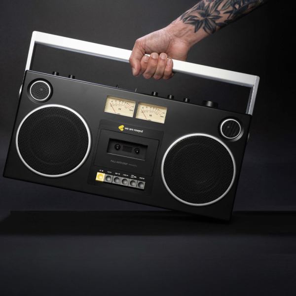 we are rewind getto blaster cassette player & recorder curtis, black Tattooed hand holding vintage portable radio.