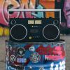 we are rewind getto blaster cassette player & recorder curtis, black Retro boombox on graffiti-covered barrel.