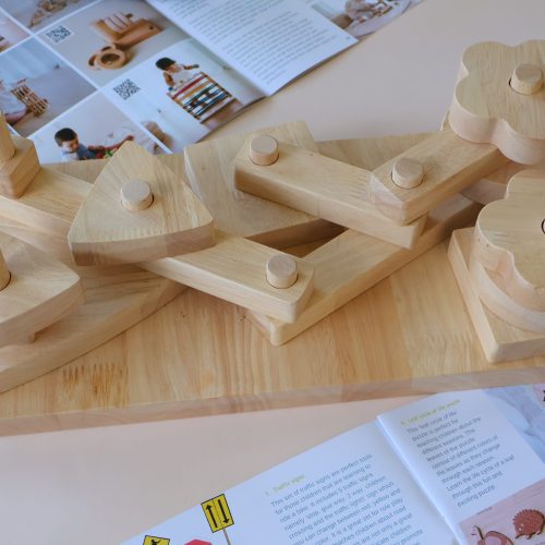 v59 626 202602031611 00.jpg Wooden stacking toy and open instruction booklet.