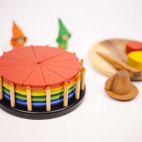 v59 631 202602031611 00.jpg Colourful wooden toy cake and shapes on table.