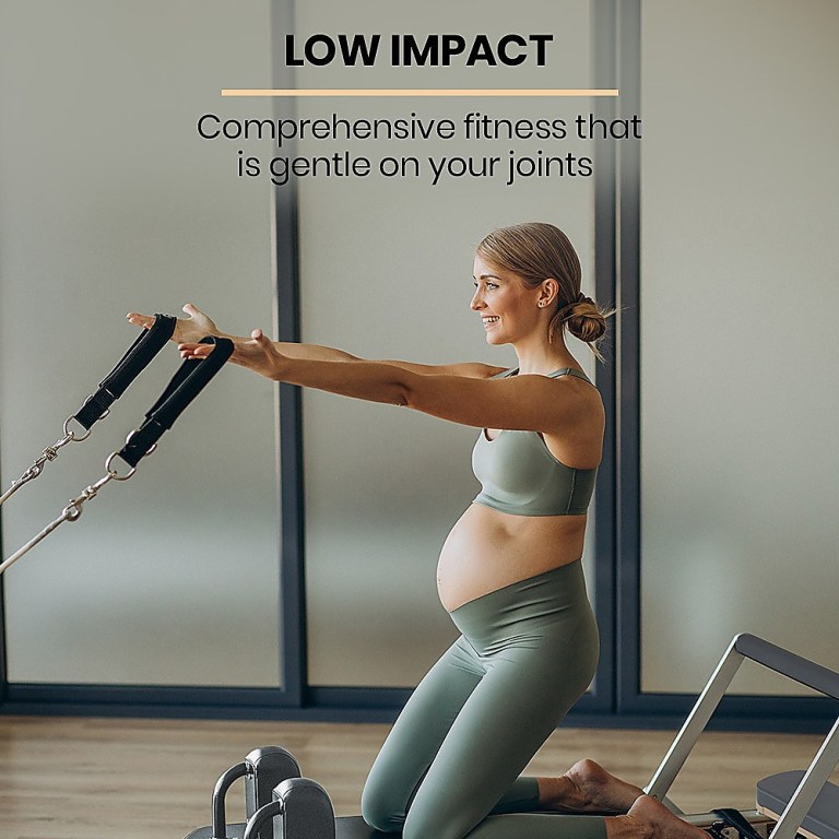 Pregnant woman doing low impact exercise with straps.