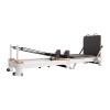 folding pilates reformer machine – home workout bed for full body fitness training Pilates reformer exercise machine on white background.