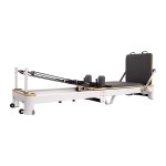 Pilates reformer exercise machine on white background.