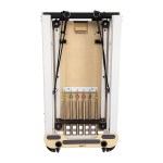 Foldable Pilates reformer with springs and straps.