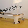 folding pilates reformer machine – home workout bed for full body fitness training Pilates reformer machine on wooden floor