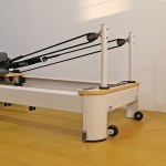 Pilates reformer machine on wooden floor