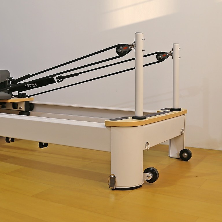 Pilates reformer machine on wooden floor