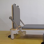 Reformer Pilates machine with adjustable backrest.