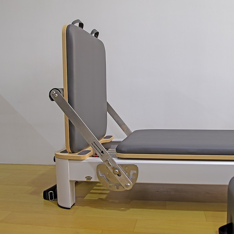 Reformer Pilates machine with adjustable backrest.