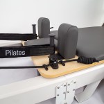 Close-up of Pilates reformer machine equipment.