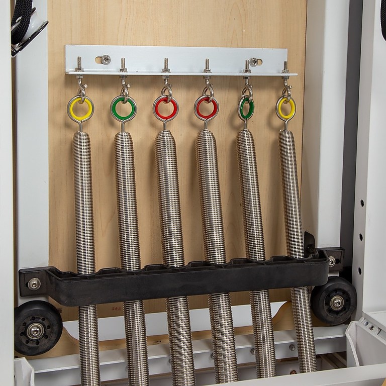 Reformer Pilates springs with coloured tension rings.