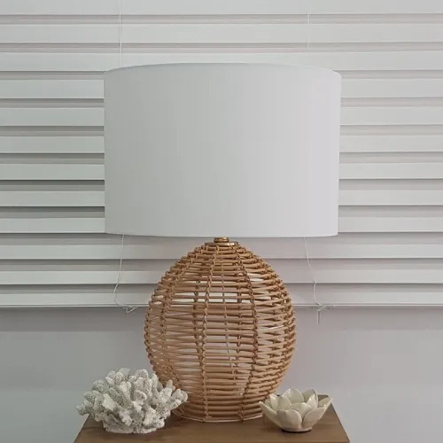 Wicker lamp with coral and lotus decor items.
