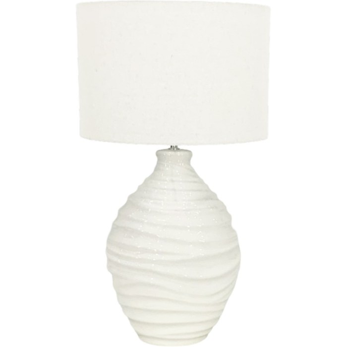 White ceramic table lamp with textured base.