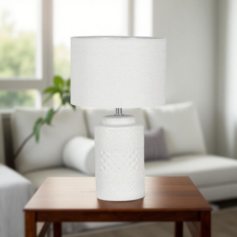 yarra table lamp 38cm White ceramic lamp on wooden table in living room.