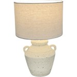 Ceramic table lamp with textured base and fabric shade.