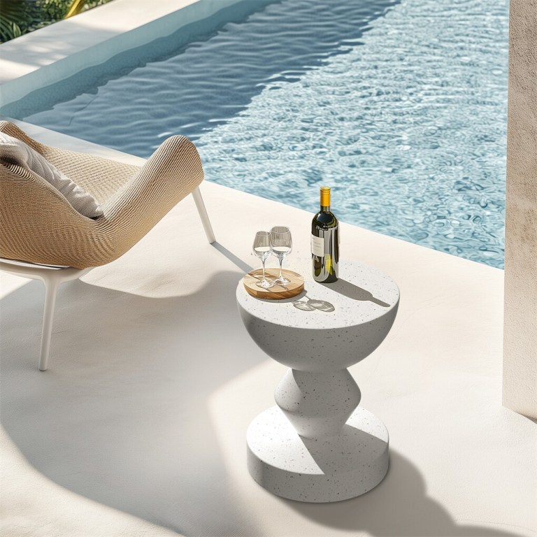 Outdoor chair and table beside a pool.