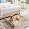 Golden retriever on soft bed in bright bedroom.
