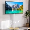 TV displaying serene mountain lake scenery indoors.