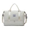 Cream quilted duffle bag with shoulder strap
