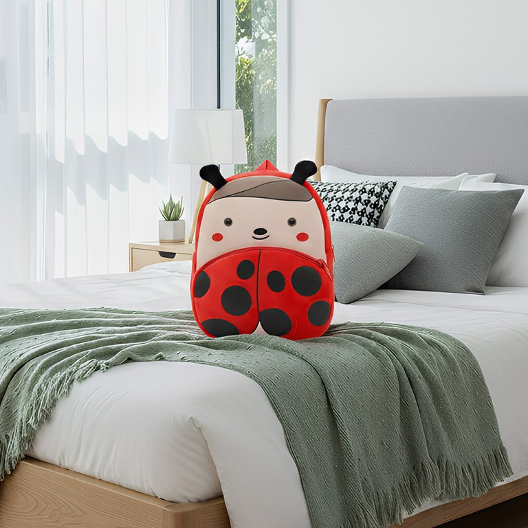 Ladybug children’s backpack on neatly made bed