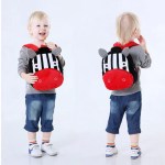 Toddler wearing zebra backpack, front and back views