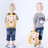 Toddler wearing yellow lion backpack