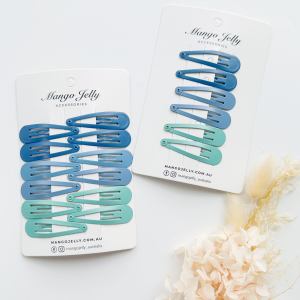 Blue and teal snap hair clips on cards
