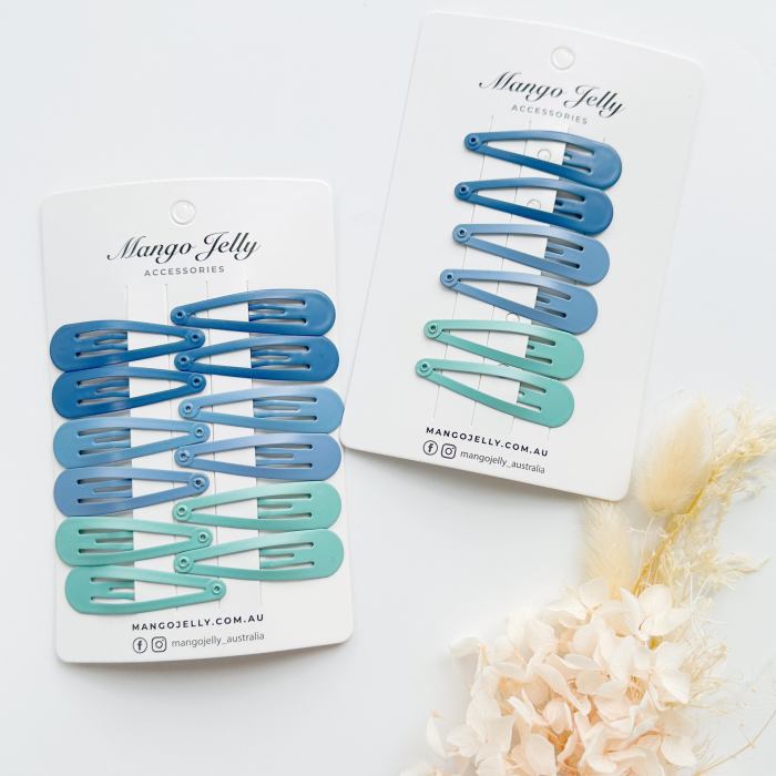 Blue and teal snap hair clips on cards