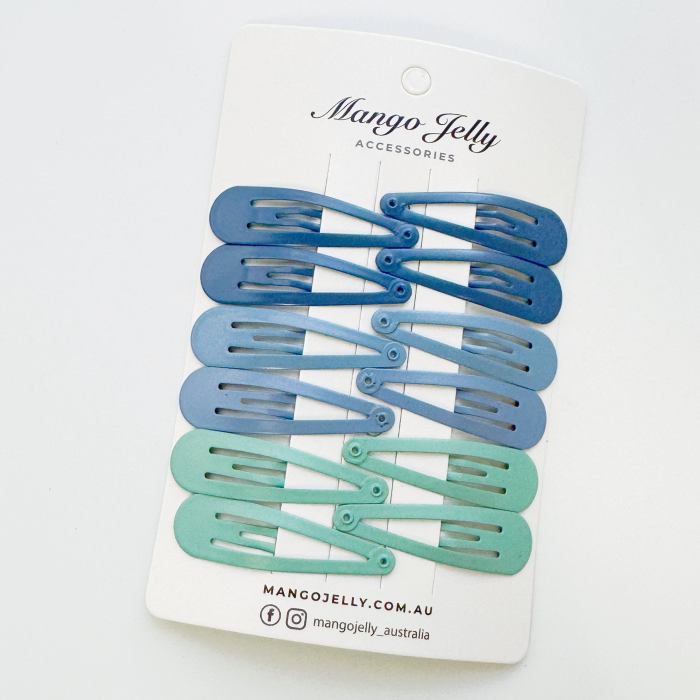 Blue and mint snap hair clips on card