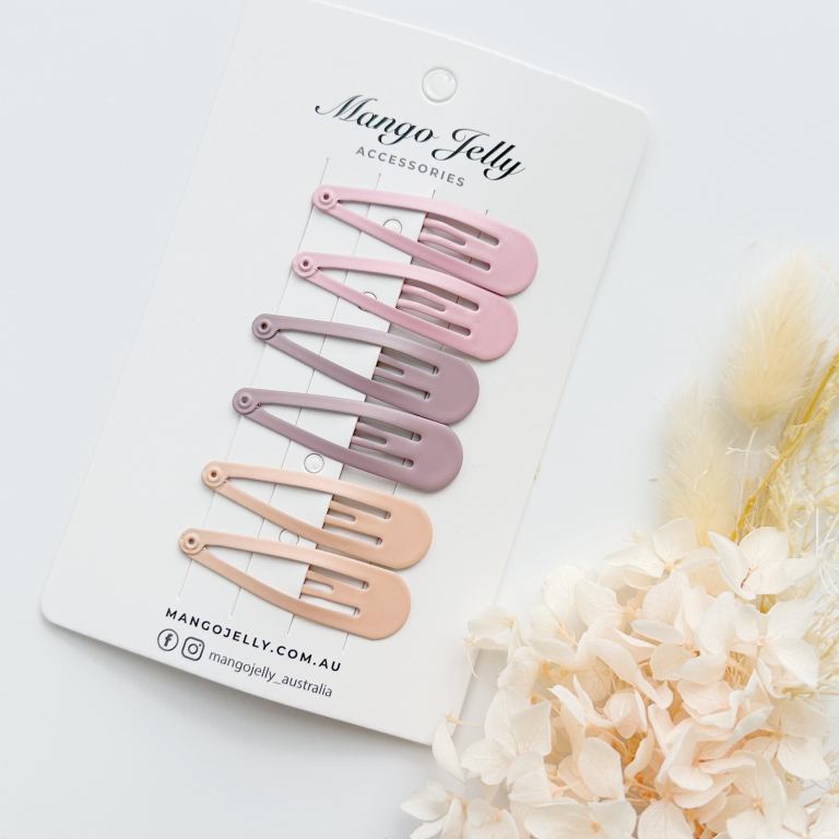 Pastel snap hair clips on display card