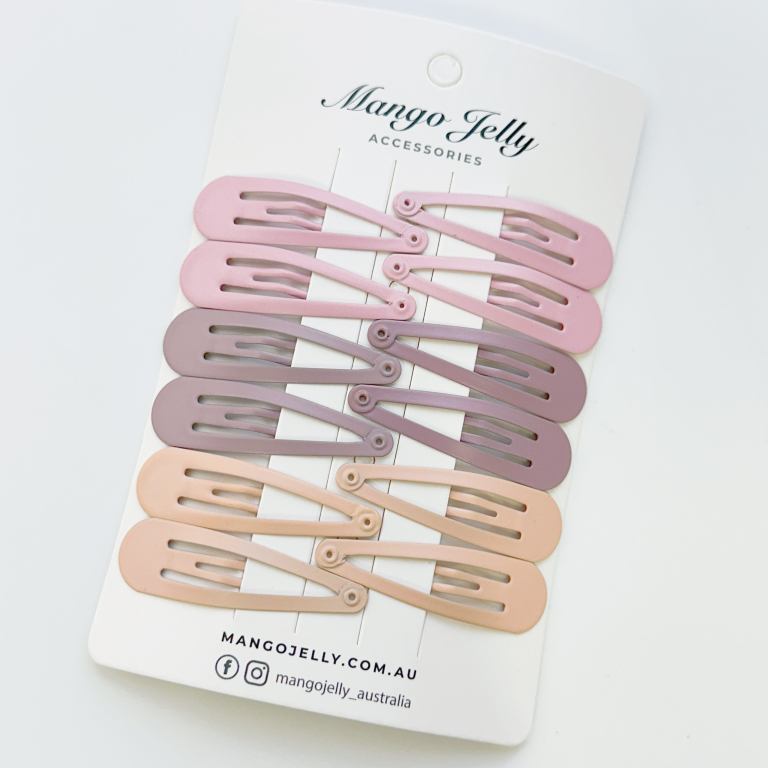 Pastel snap hair clips on branded card