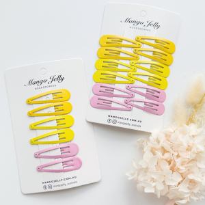 Yellow and pink snap hair clips on display cards